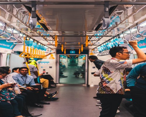 Commuters standing comfortably inside a Jakarta public transit train